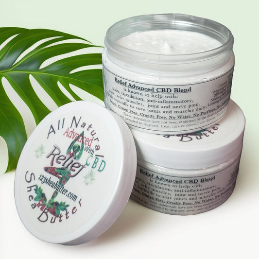 A jar of All Natural Pan Relief Advanced Blend Sheabutter with the lid off, showing the white creamy product inside. The label on the jar lists the ingredients and emphasizes its organic and pain relief properties.