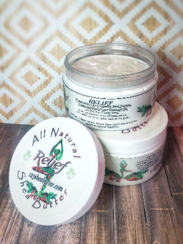 two jars of Relief Shea butter with top jar open and lid laying on the side of the jar with wood backdrop