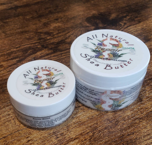 Two jars of one 4oz and one 2oz All Natural Repair Shea Butter on a wooden surface