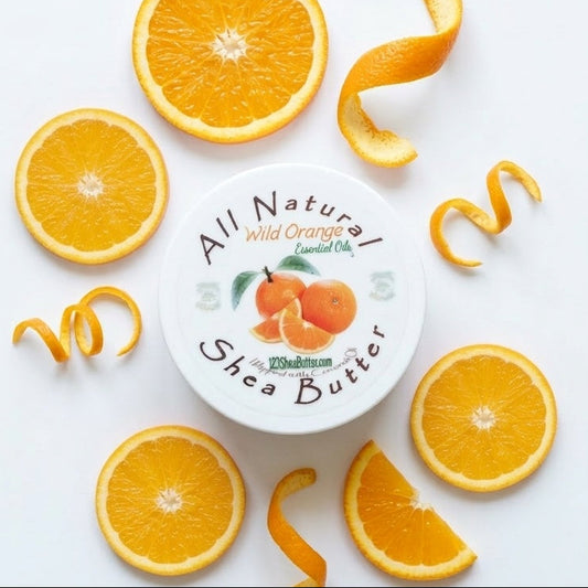 Shea butter container with wild orange flavor surrounded by sliced oranges on a white background