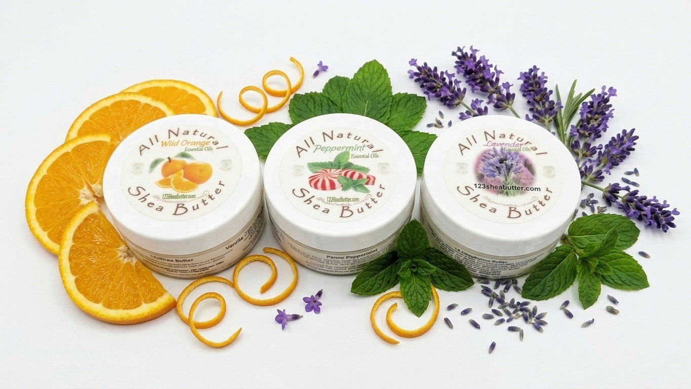 Three jars of All Natural Shea Butter with orange slices, lavender flowers, and green leaves on a white background.
