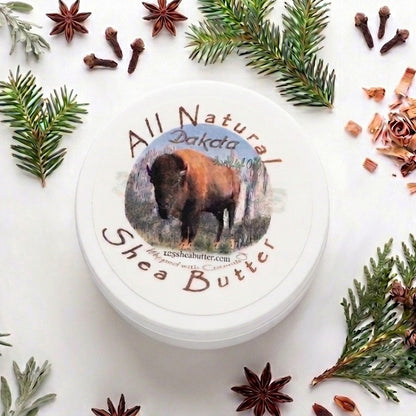 Jar of All Natural Dakota Shea Butter surrounded by decorative elements on a white background