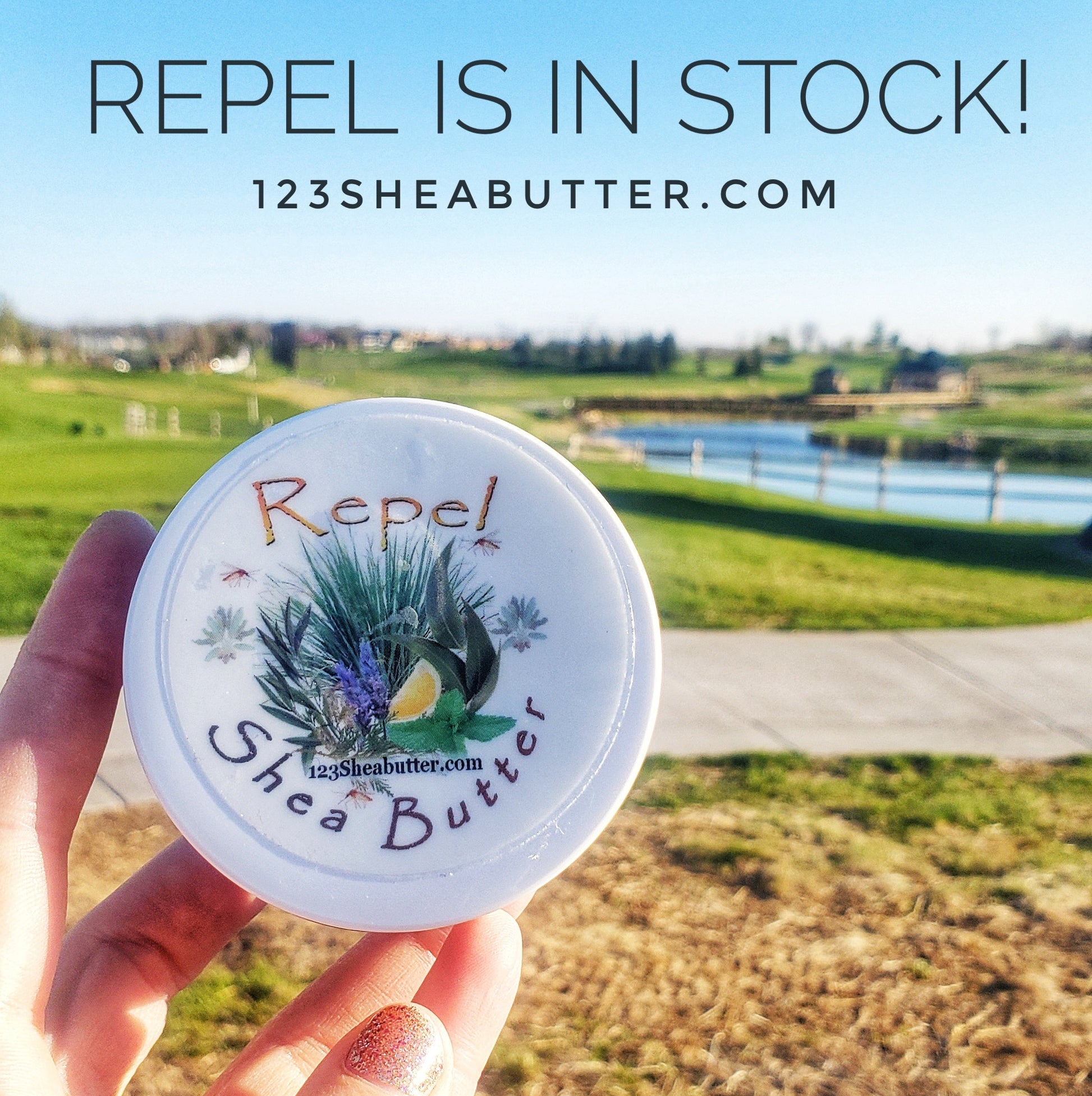 Hand holding a container of Repel Shea Butter with a scenic background