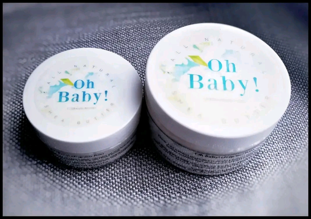 Two containers of 'Oh Baby!' cream on a textured surface