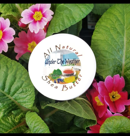 Under the Weather Shea butter container with flowers and leaves in the background