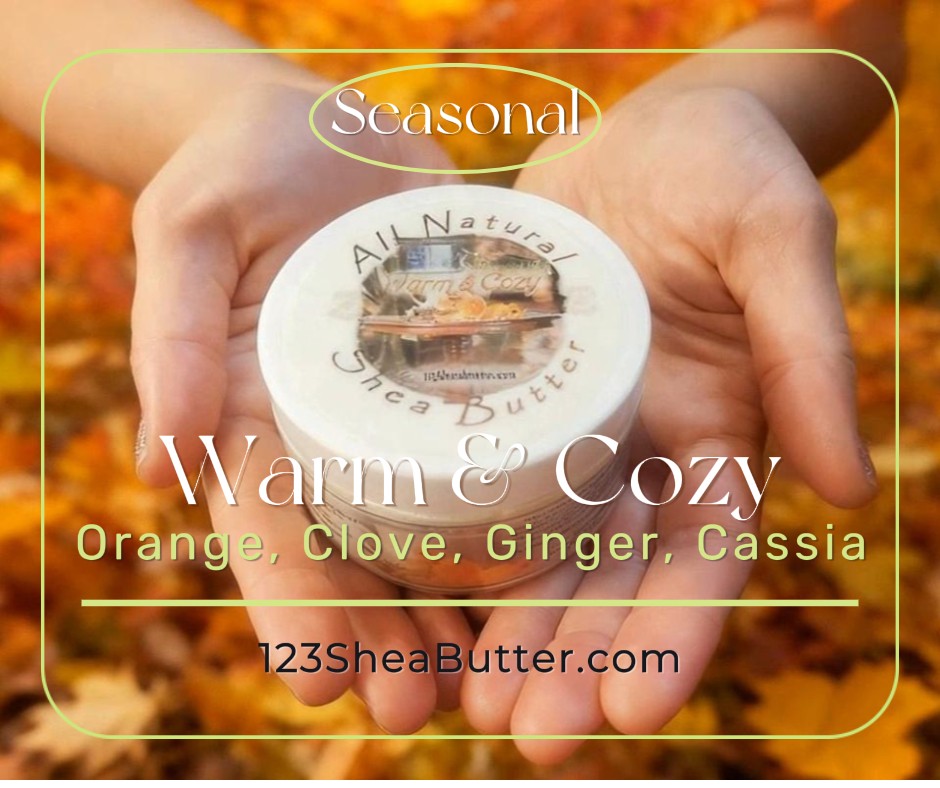 Jar of shea butter held in hands with autumn leaves in the background, featuring '123SheaButter.com'.