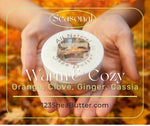 Jar of shea butter held in hands with autumn leaves in the background, featuring '123SheaButter.com'.