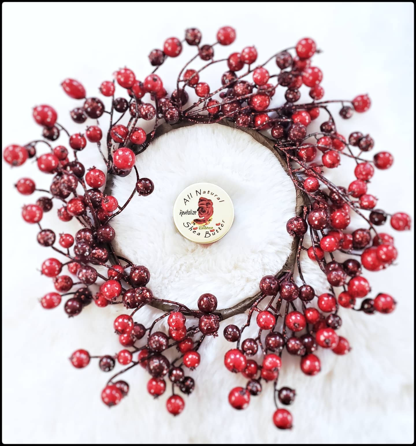 rose travel size surrounded by a wreath of berries with white background