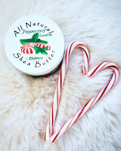 Peppermint Shea butter jar with white background and two candy canes in the shape of a heart next to it